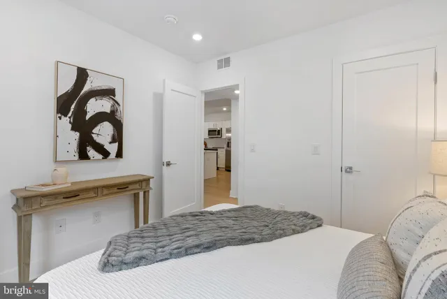 a bedroom with a bed and a dresser