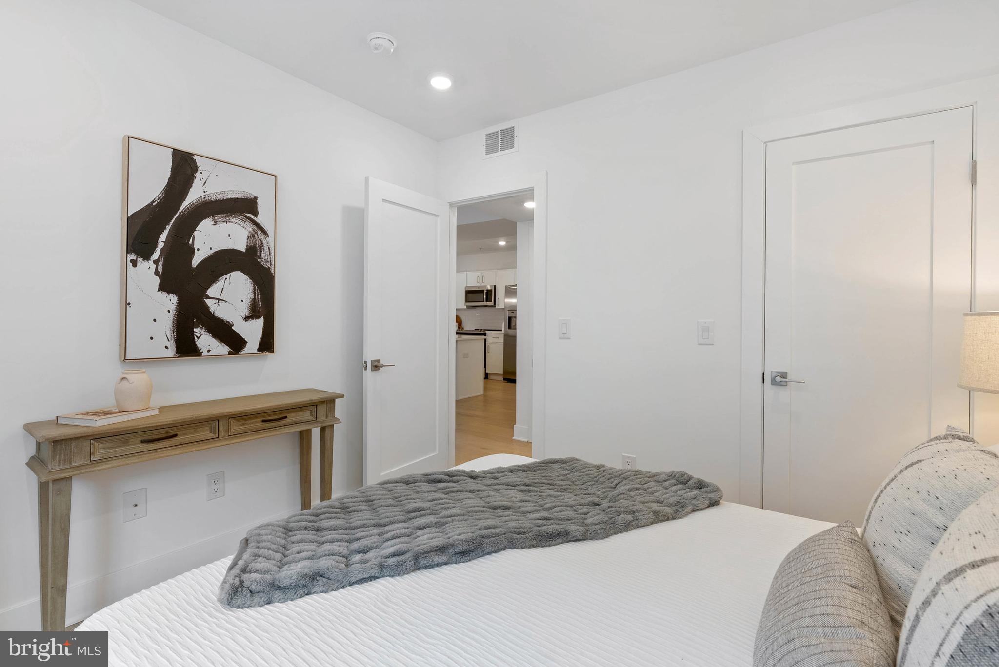 825 Bainbridge Street, Unit 101 Philadelphia, PA 19147 - Photo 14 of 27 a bedroom with a bed and a dresser