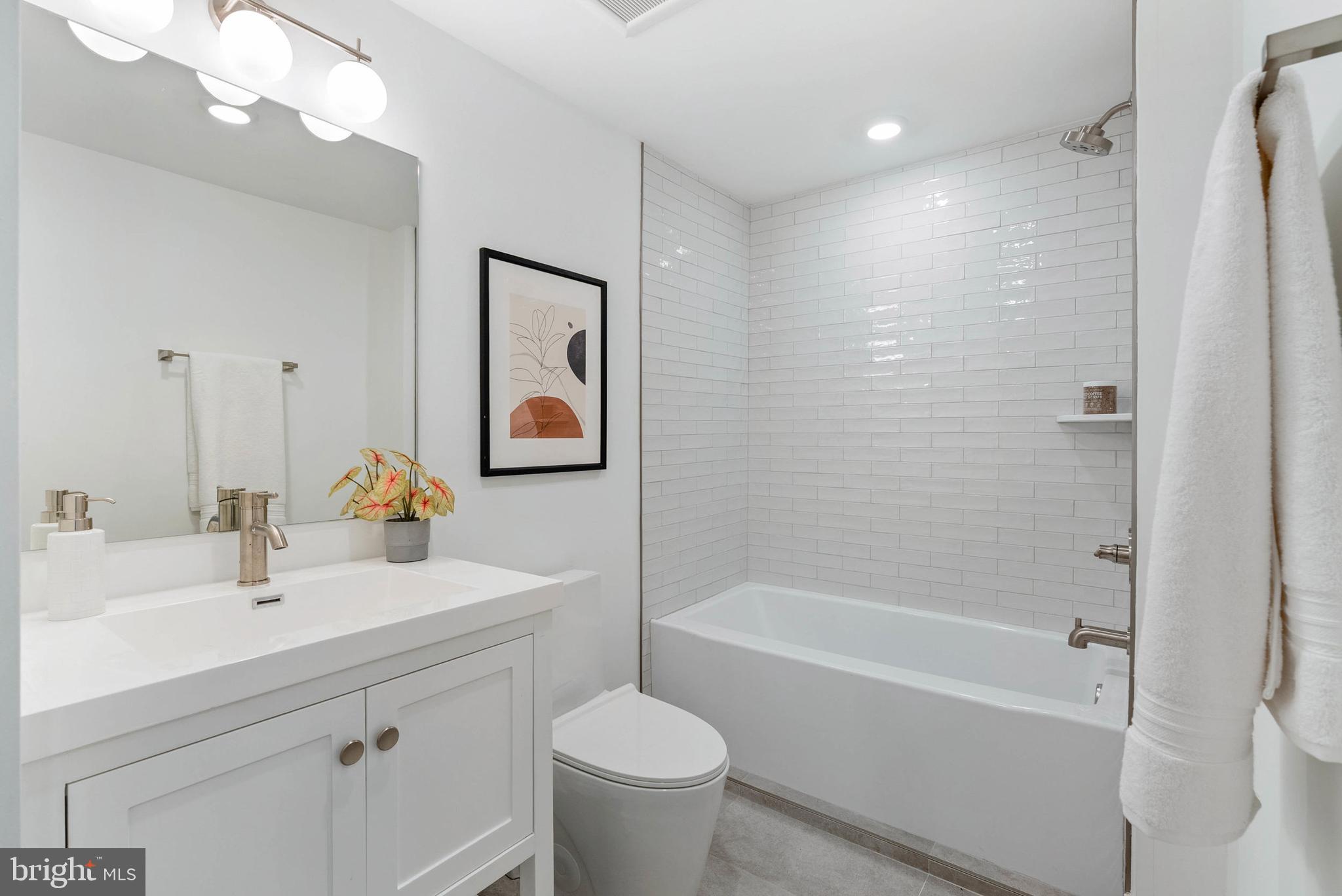 825 Bainbridge Street, Unit 101 Philadelphia, PA 19147 - Photo 15 of 27 a bathroom with a sink toilet and shower