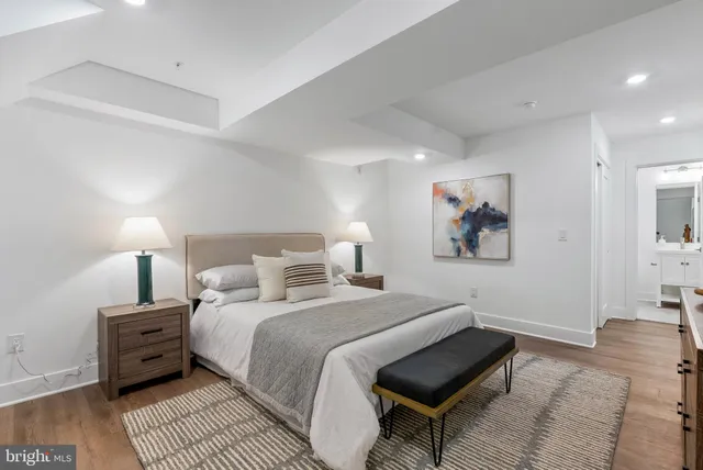 a bedroom with a bed and a lamp