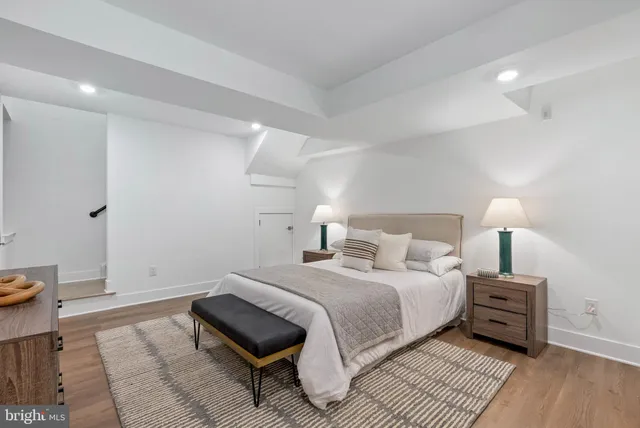 a bedroom with a bed and a night stand