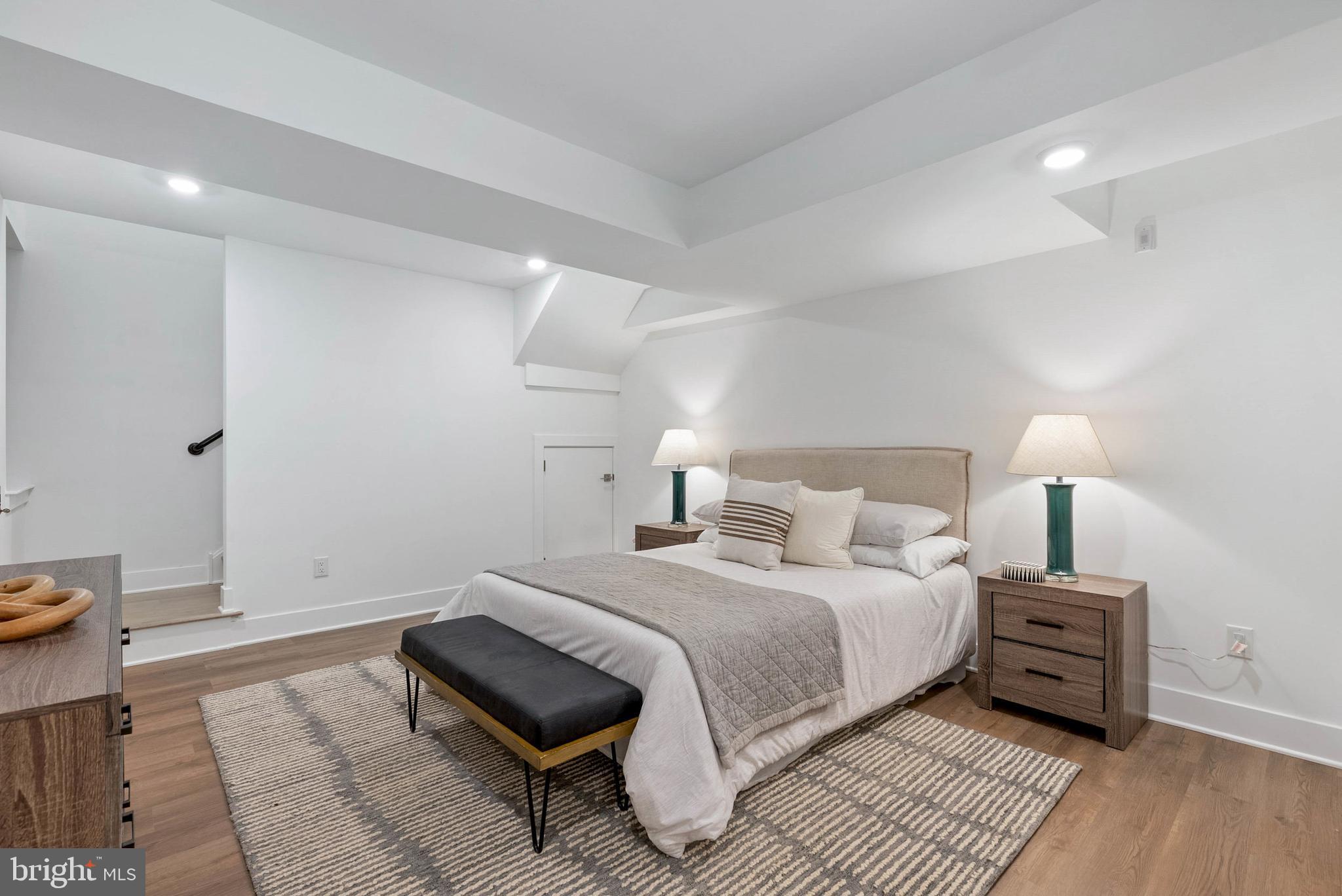 825 Bainbridge Street, Unit 101 Philadelphia, PA 19147 - Photo 17 of 27 a bedroom with a bed and a night stand