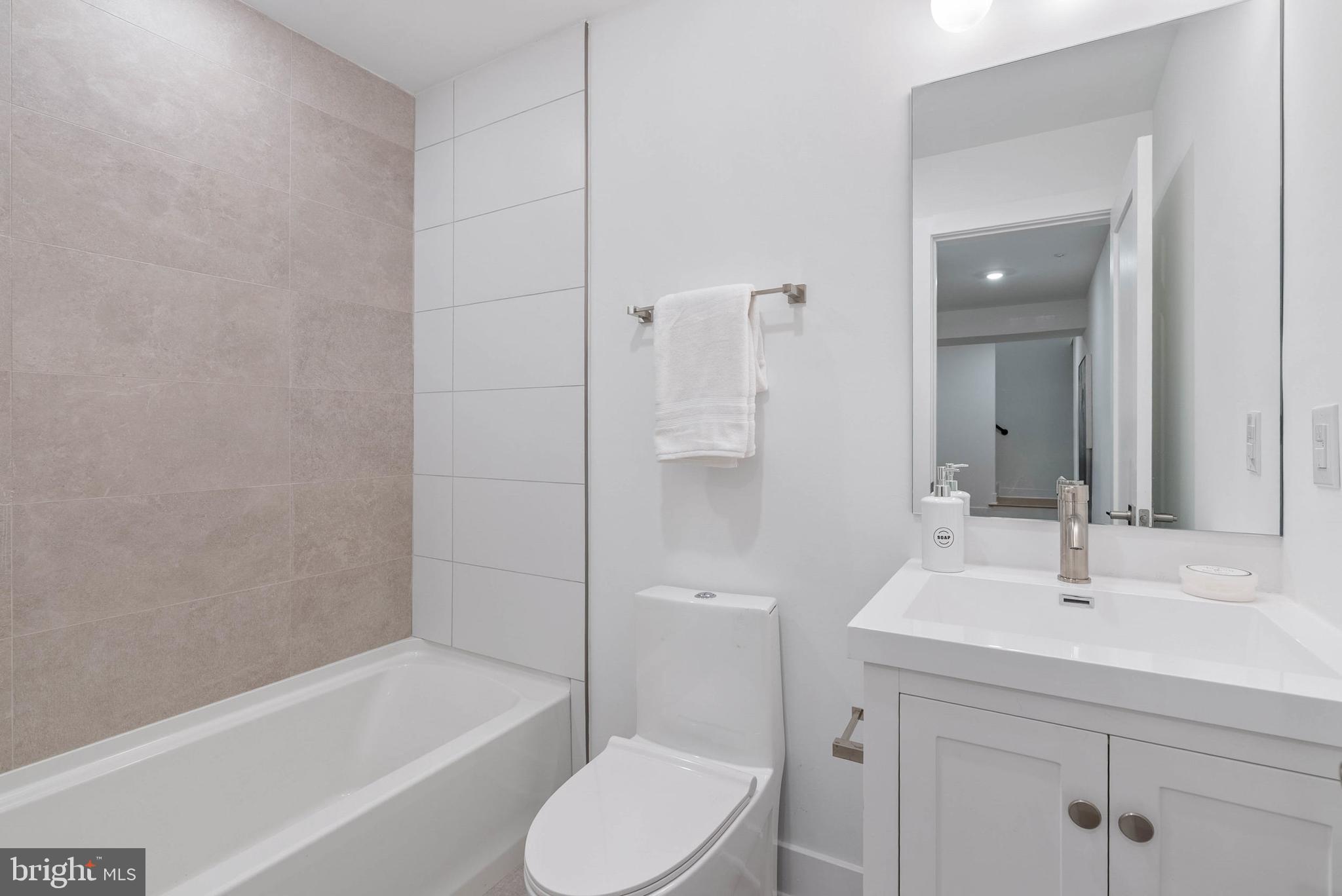 825 Bainbridge Street, Unit 101 Philadelphia, PA 19147 - Photo 19 of 27 a bathroom with a sink toilet and shower