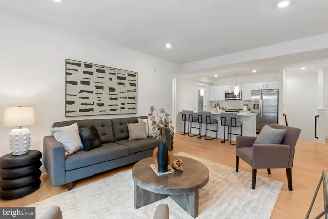 a living room with furniture and a wooden floor