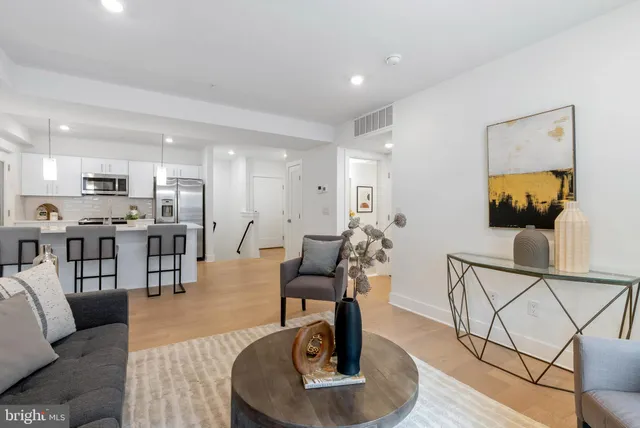 a living room with furniture and kitchen view