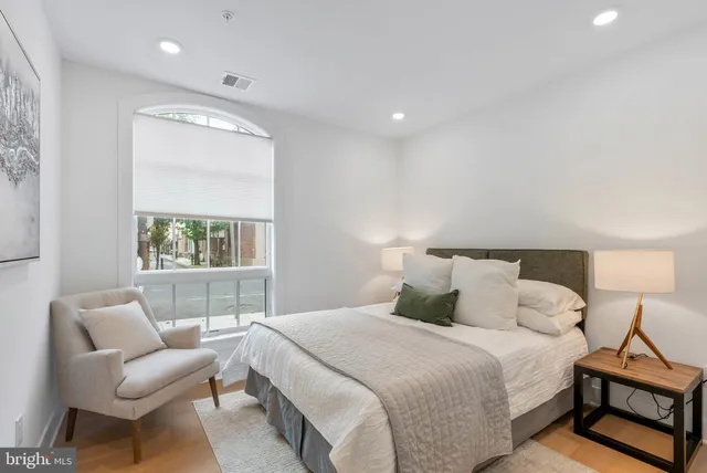 a bedroom with a bed and a couch