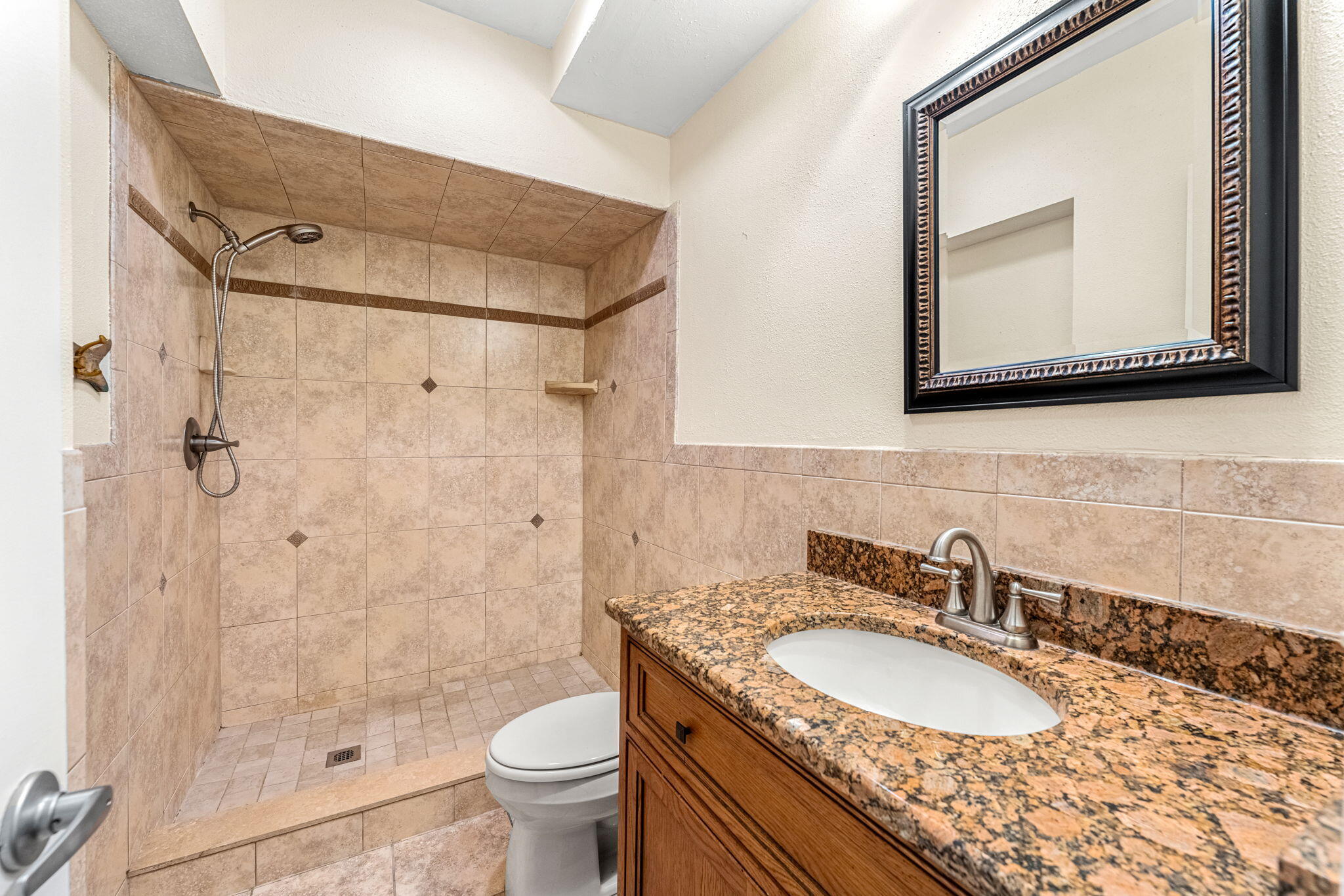 3 Cove Road, Unit 3 Melbourne Beach, FL 32951 - Photo 19 of 40 a bathroom with a granite countertop sink toilet and a mirror