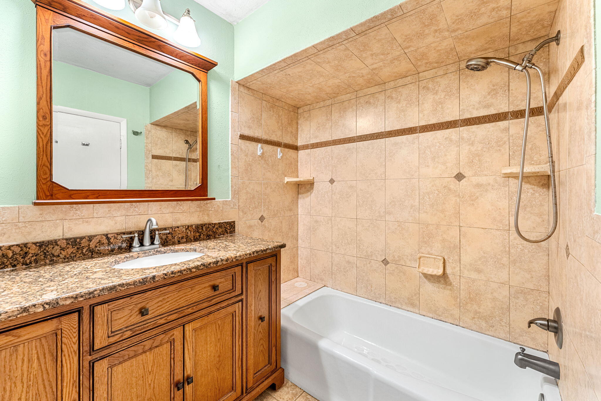 3 Cove Road, Unit 3 Melbourne Beach, FL 32951 - Photo 26 of 40 a bathroom with a granite countertop sink mirror toilet and bathtub