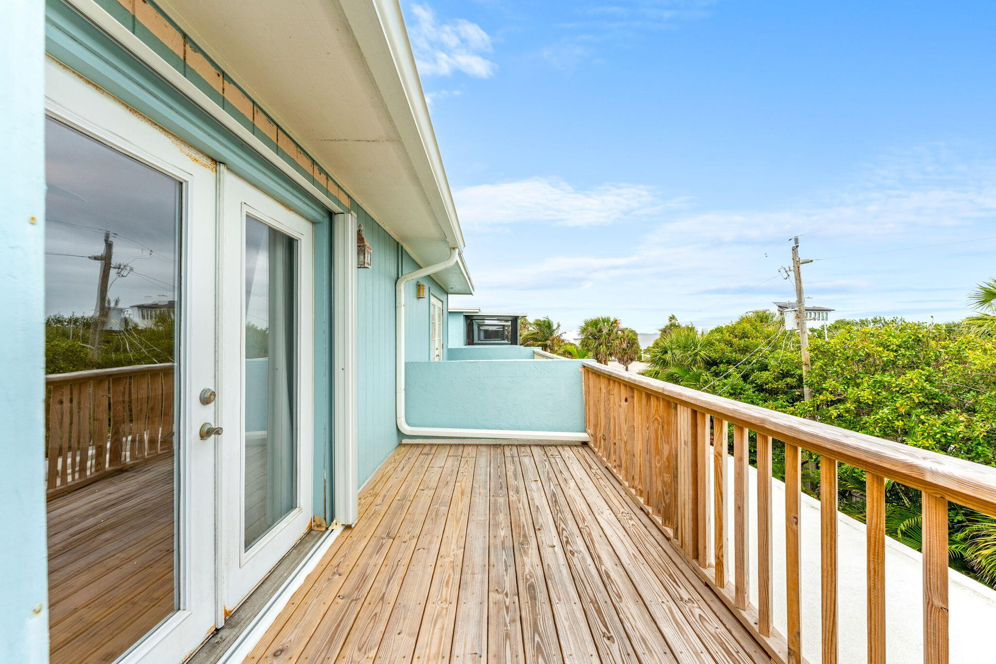 3 Cove Road, Unit 3 Melbourne Beach, FL 32951 - Photo 31 of 40 a view of a balcony with wooden floor
