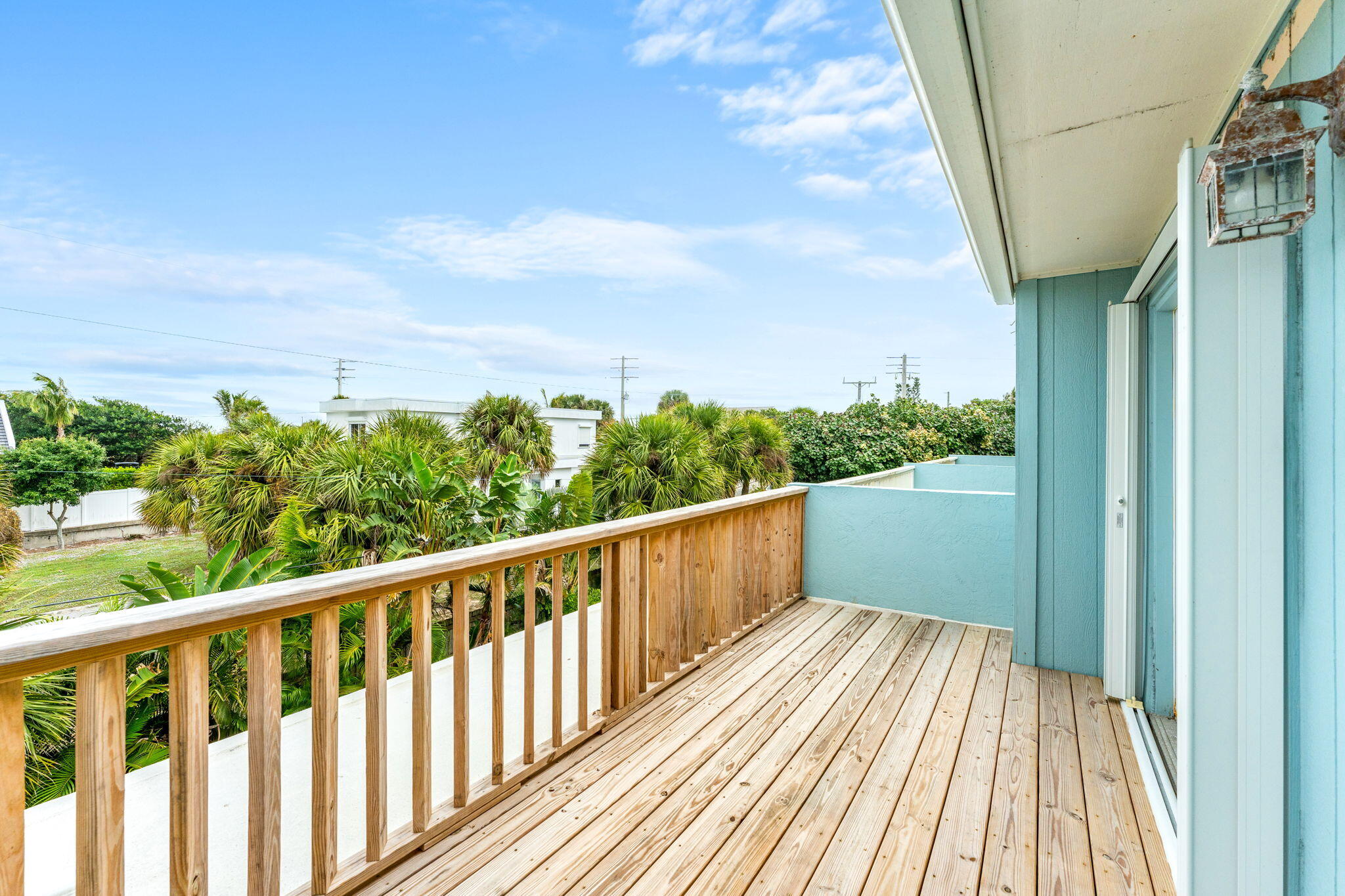 3 Cove Road, Unit 3 Melbourne Beach, FL 32951 - Photo 33 of 40 a balcony with wooden floor and fence