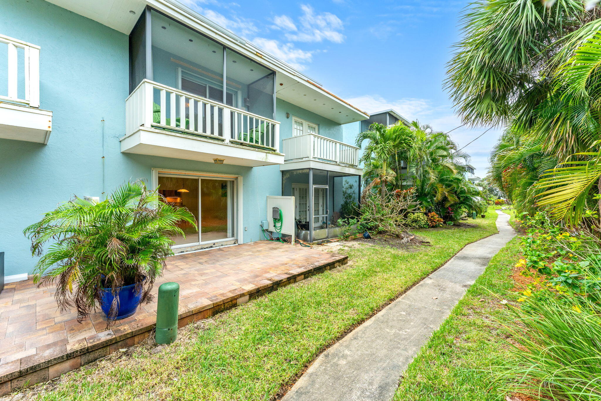 3 Cove Road, Unit 3 Melbourne Beach, FL 32951 - Photo 37 of 40 a front view of a house with a garden and patio