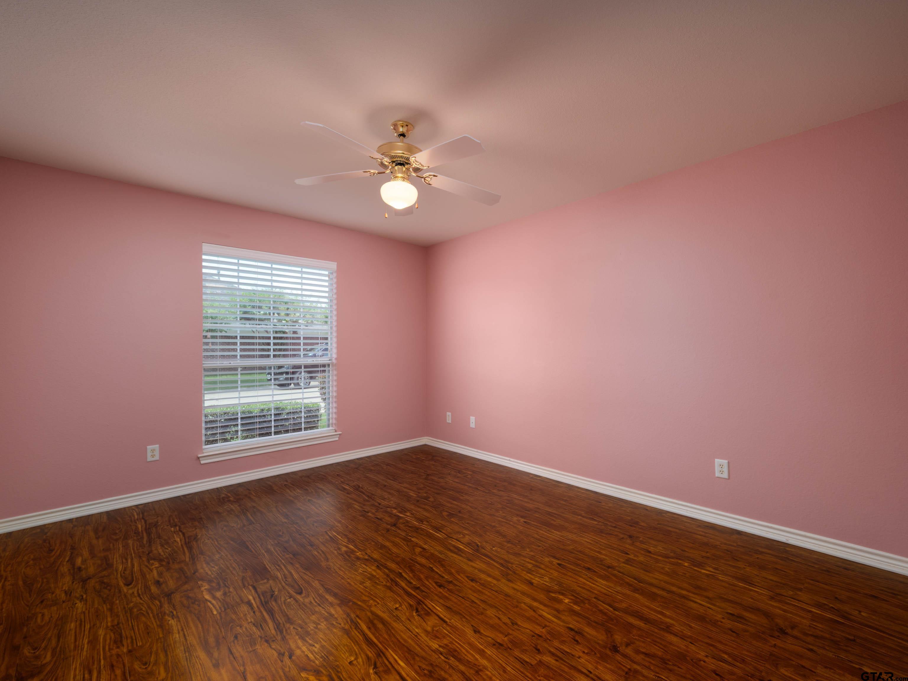 1521 Rice Road Tyler, TX 75703 - Photo 20 of 23 a view of an empty room with a window and wooden floor