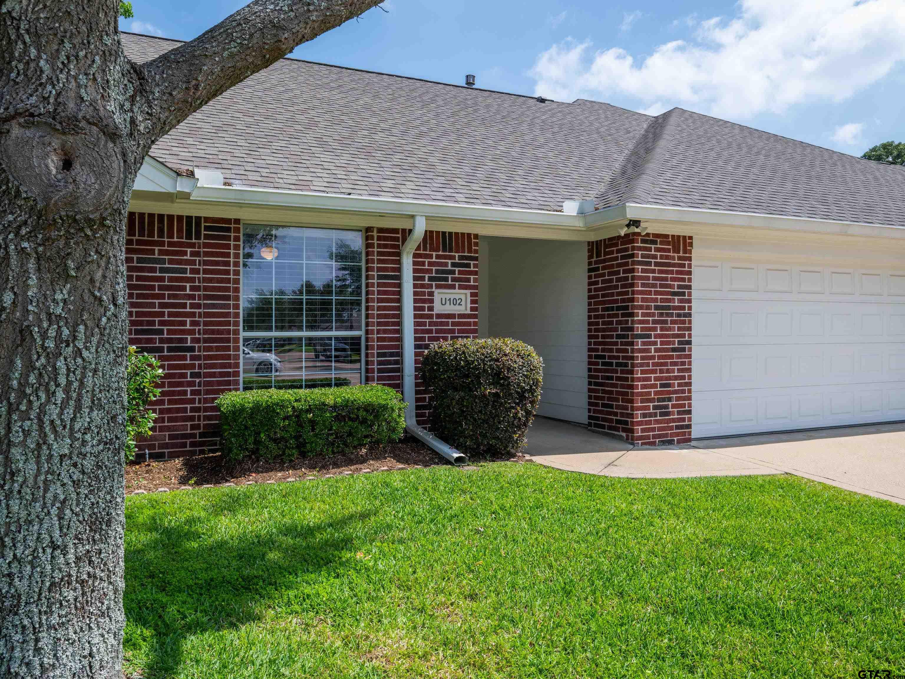 1521 Rice Road Tyler, TX 75703 - Photo 2 of 23 a view of a backyard with plants and large tree