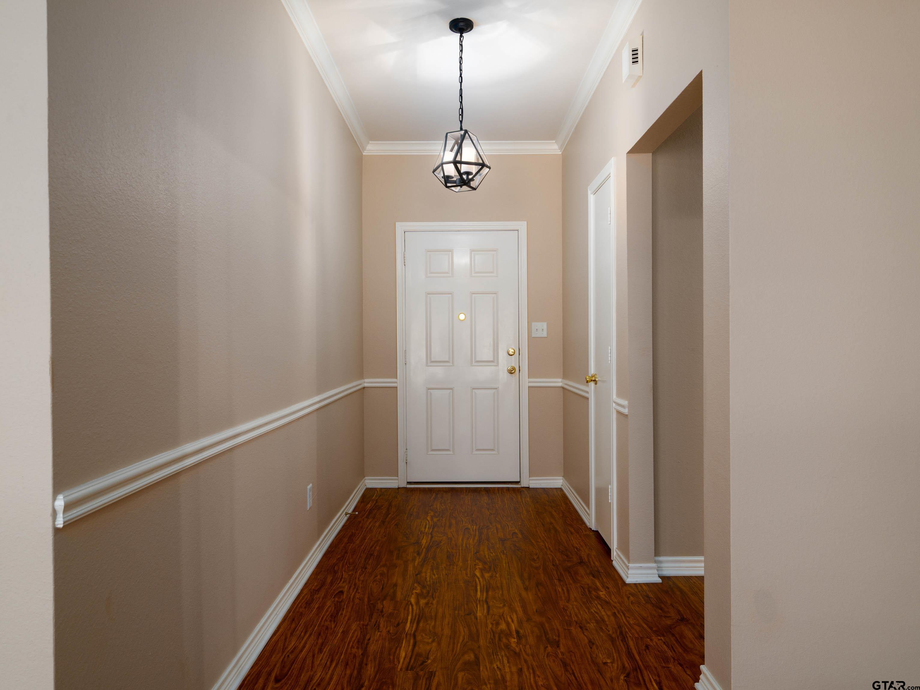 1521 Rice Road Tyler, TX 75703 - Photo 3 of 23 a view of a hallway with wooden floor and staircase