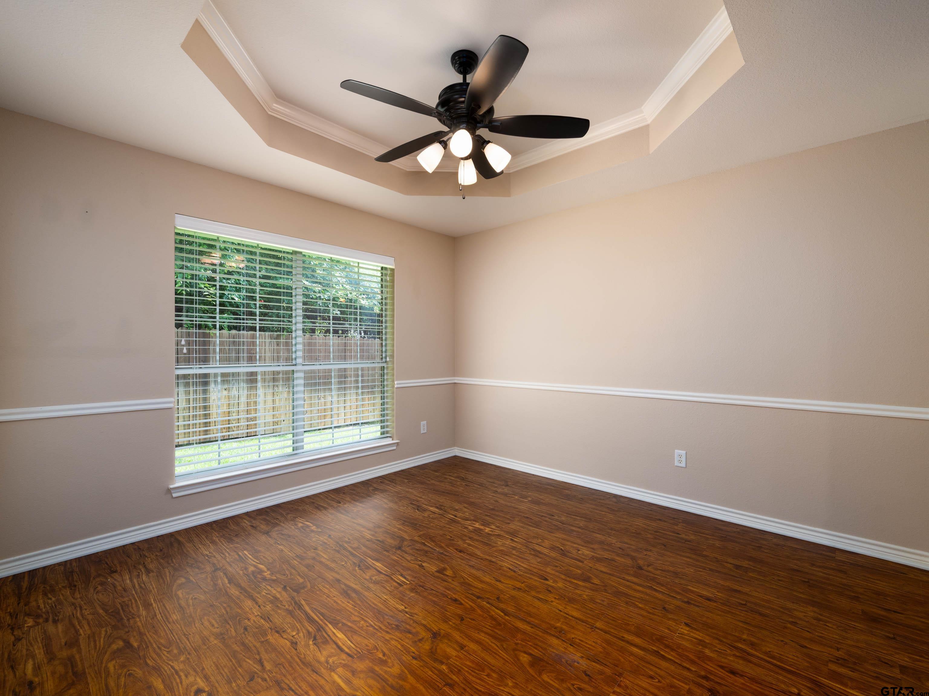 1521 Rice Road Tyler, TX 75703 - Photo 6 of 23 a view of an empty room with wooden floor and a window