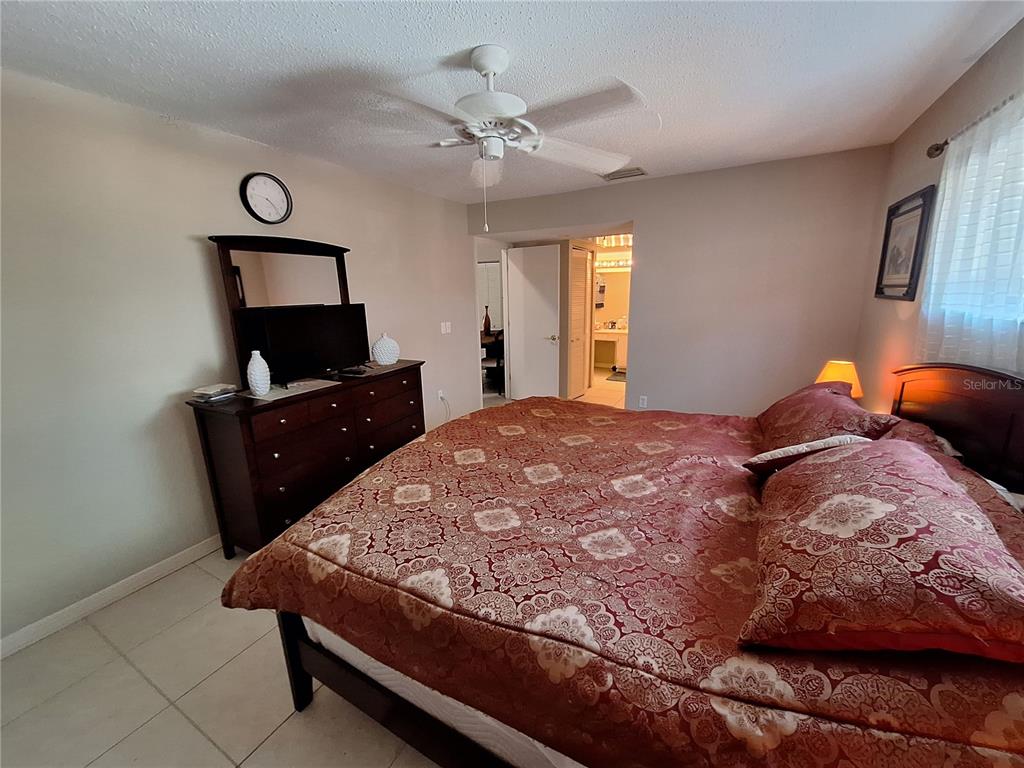 1697 Brookhouse Circle, Unit 217 Sarasota, FL 34231 - Photo 12 of 24 a bedroom with a bed and wooden floor