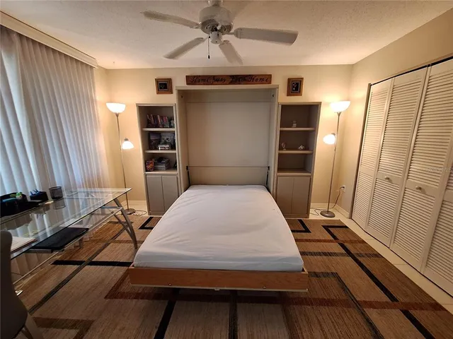 a bedroom with a bed and a mirror