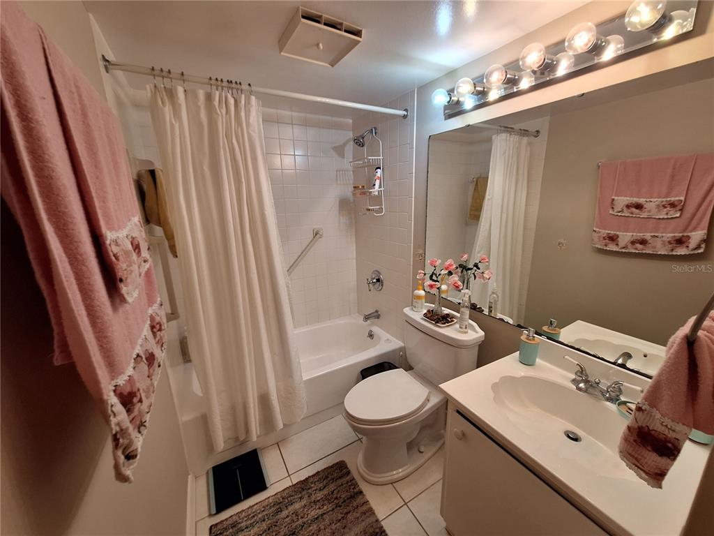 1697 Brookhouse Circle, Unit 217 Sarasota, FL 34231 - Photo 16 of 24 a bathroom with a sink toilet and shower
