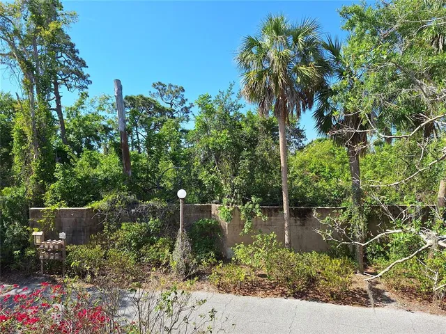 a backyard of a house with lots of green space and fountain