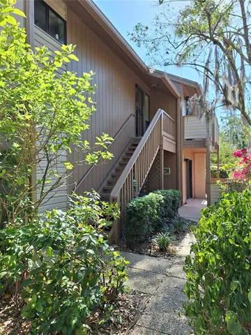 a house with a flower garden in front of it