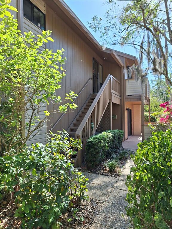 1697 Brookhouse Circle, Unit 217 Sarasota, FL 34231 - Photo 2 of 24 a house with a flower garden in front of it