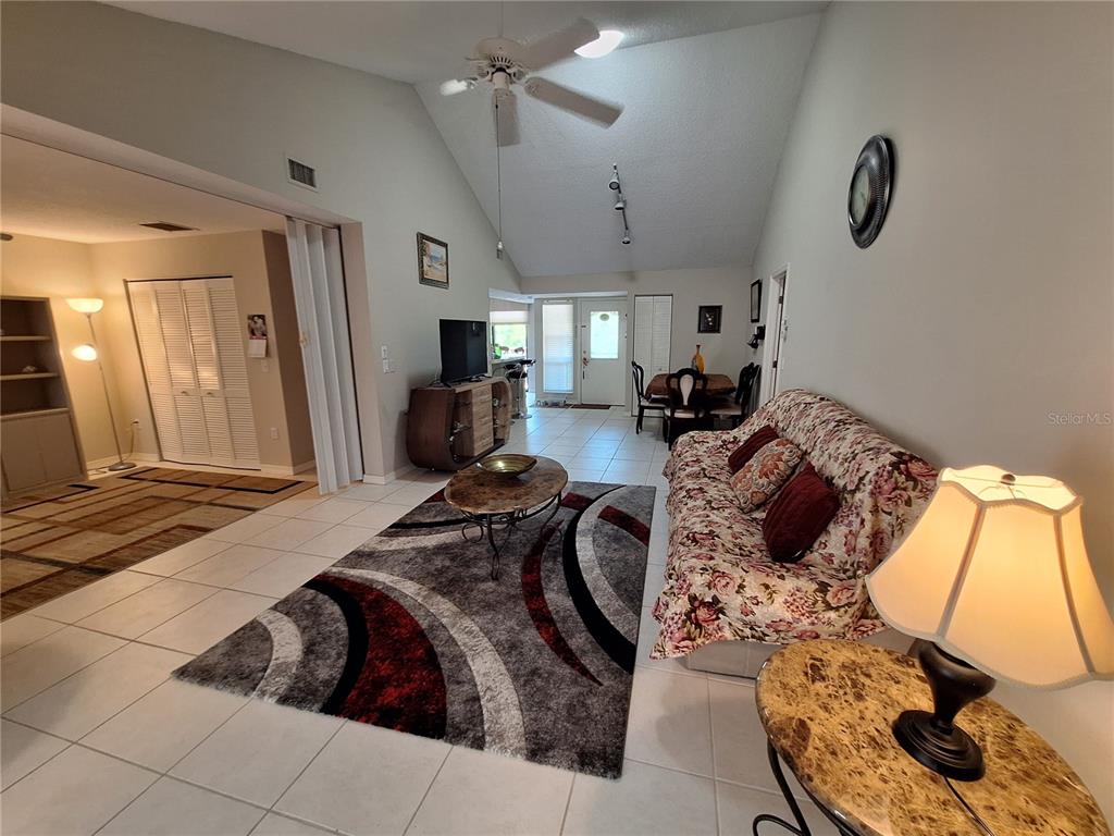 1697 Brookhouse Circle, Unit 217 Sarasota, FL 34231 - Photo 4 of 24 a bed room with furniture and a chandelier