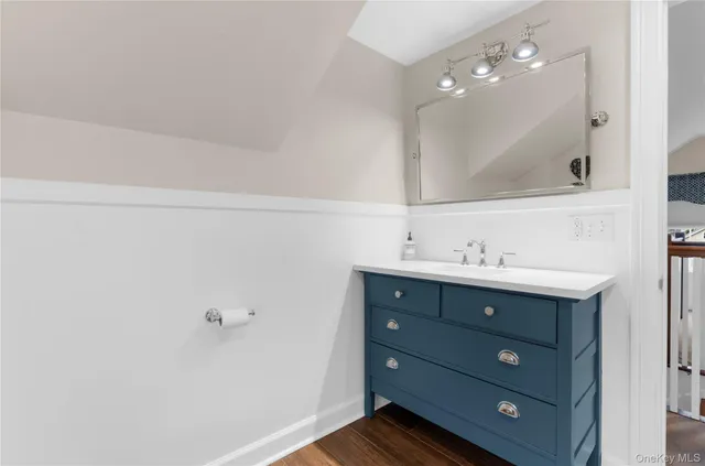 a bathroom with a sink vanity and mirror