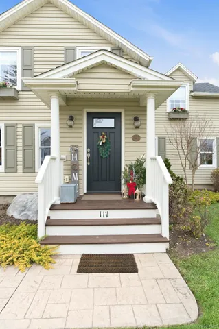 a view of a house with a fountain and large windows