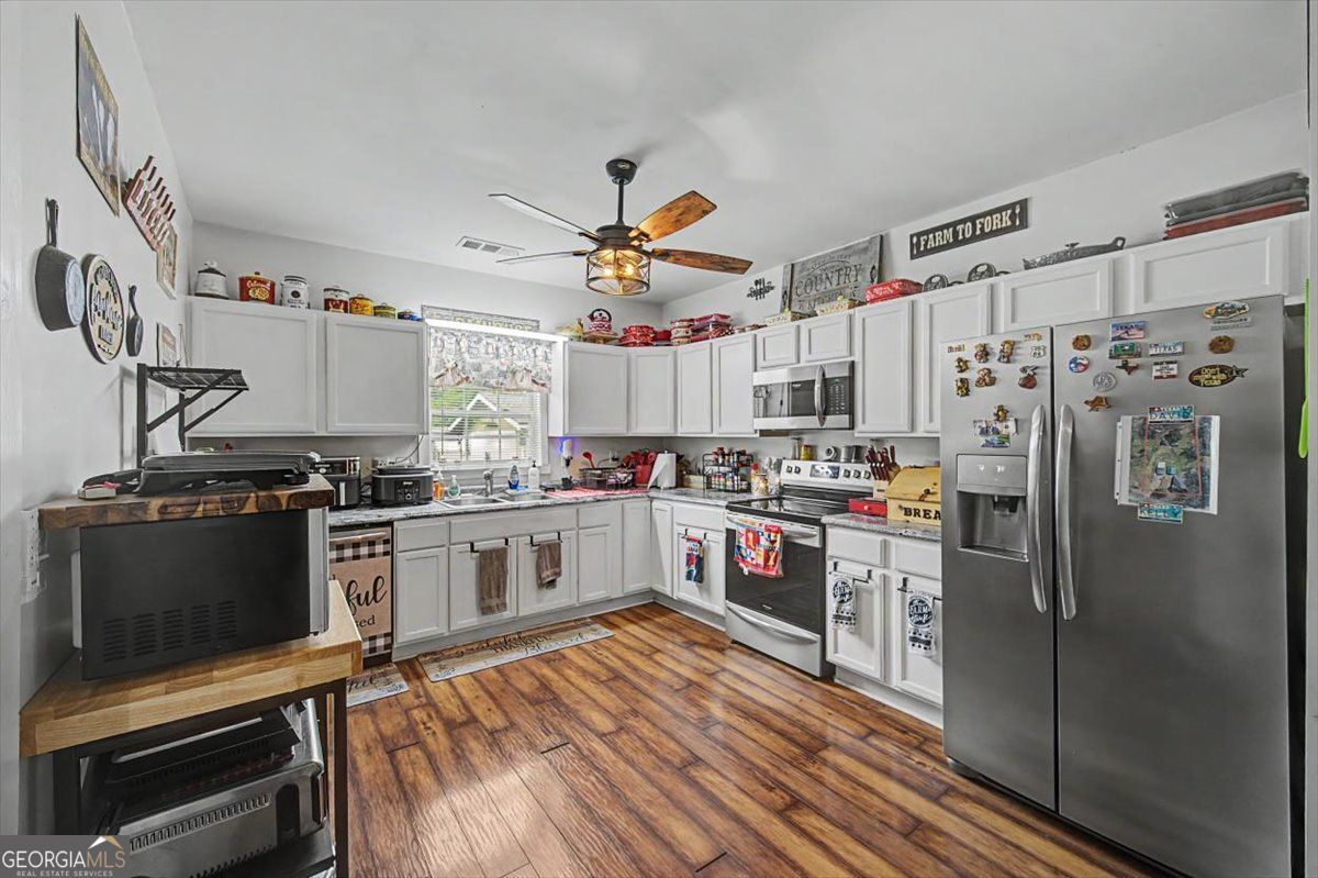 483 Coal Road Northwest Resaca, GA 30735 - Photo 20 of 56 a kitchen with stainless steel appliances a stove a refrigerator and a sink