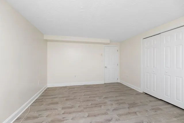 a kitchen with a sink a stove a refrigerator and white cabinets