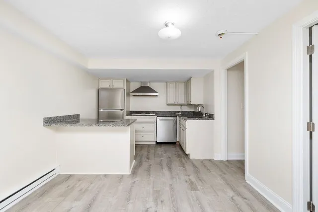 a kitchen with granite countertop a sink and cabinets
