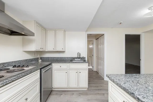 a kitchen with a stove and a refrigerator
