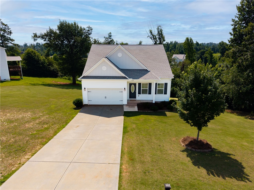 768 Rocky Ridge Circle Seneca, SC 29678 - Photo 25 of 30 A well-maintained lawn embraces this charming home, showcasing a welcoming concrete driveway.