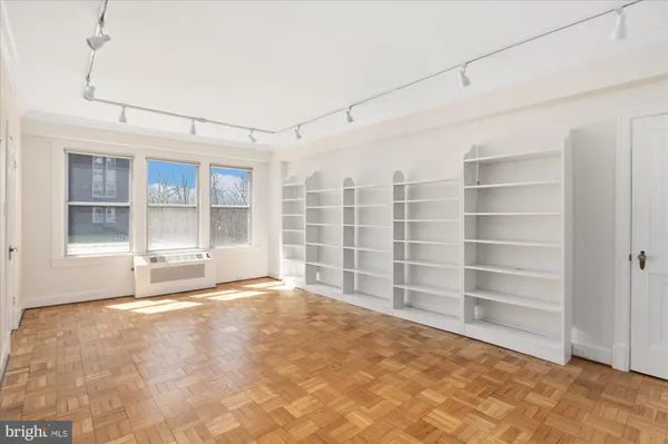 a view of a livingroom with wooden furniture