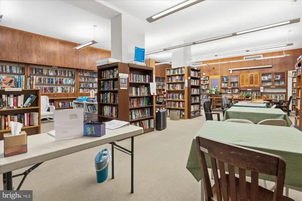 a reading room with furniture and a book shelf