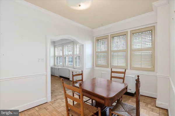 a view of a dining room with furniture and a window