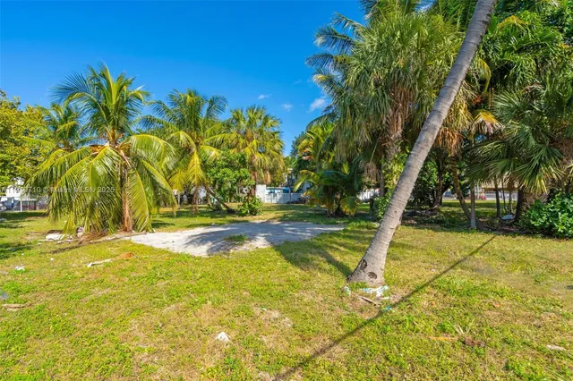 a view of swimming pool with large trees