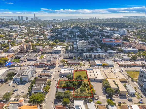 an aerial view of residential building with green space