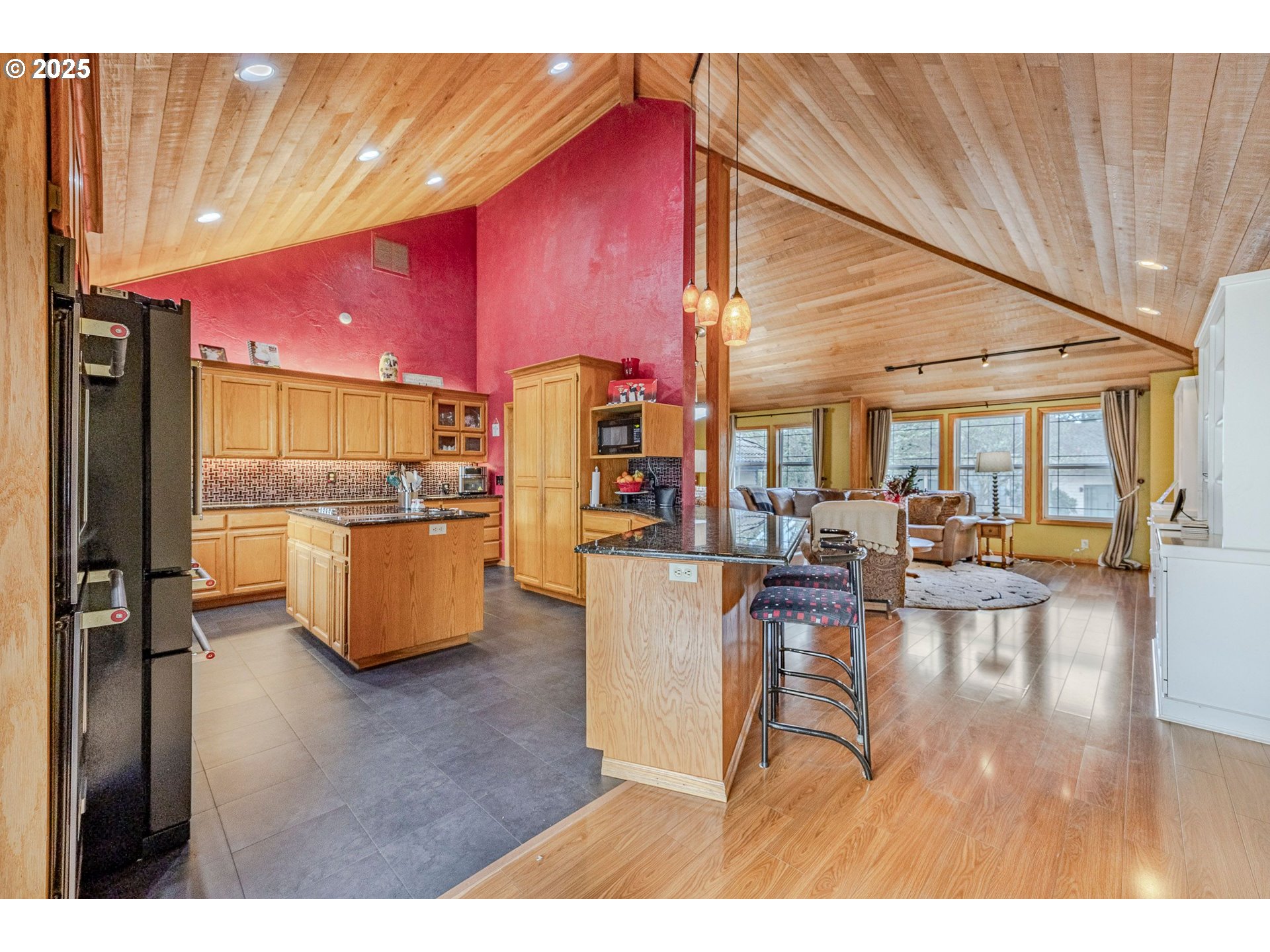1710 White Oak Drive Eugene, OR 97405 - Photo 17 of 45 a living room with couches and kitchen view with wooden floor