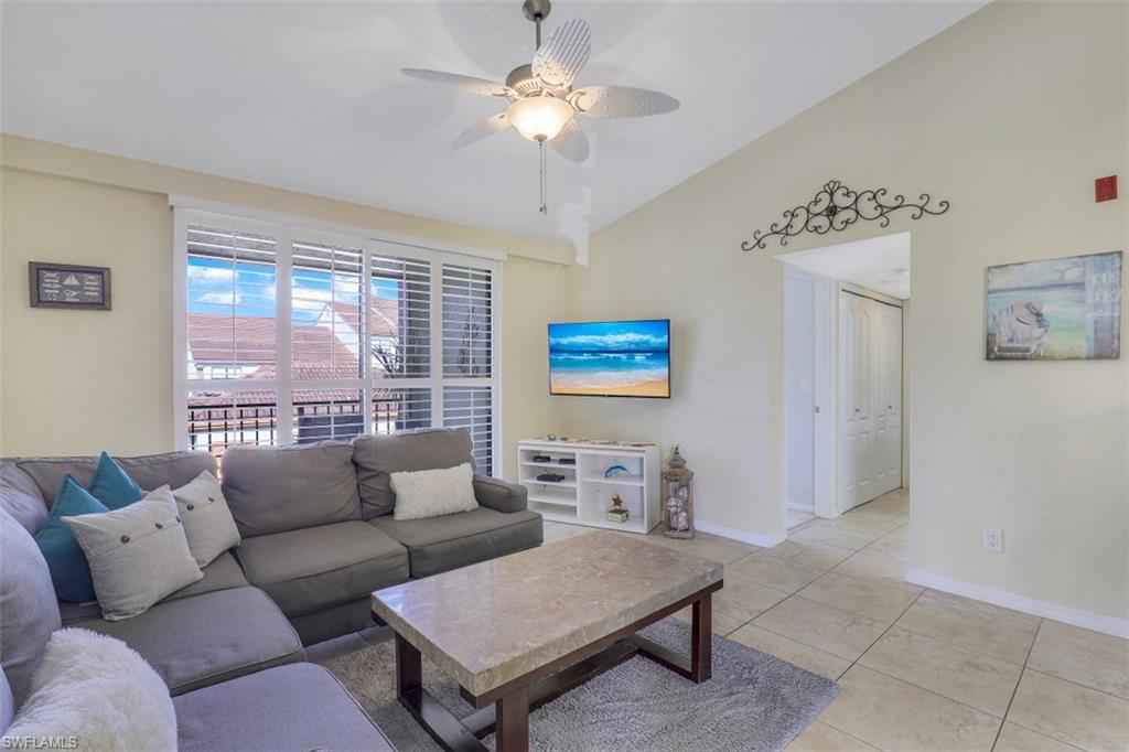 13621 Eagle Ridge Drive, Unit 1522 Fort Myers, FL 33912 - Photo 1 of 22 a living room with furniture and a large window