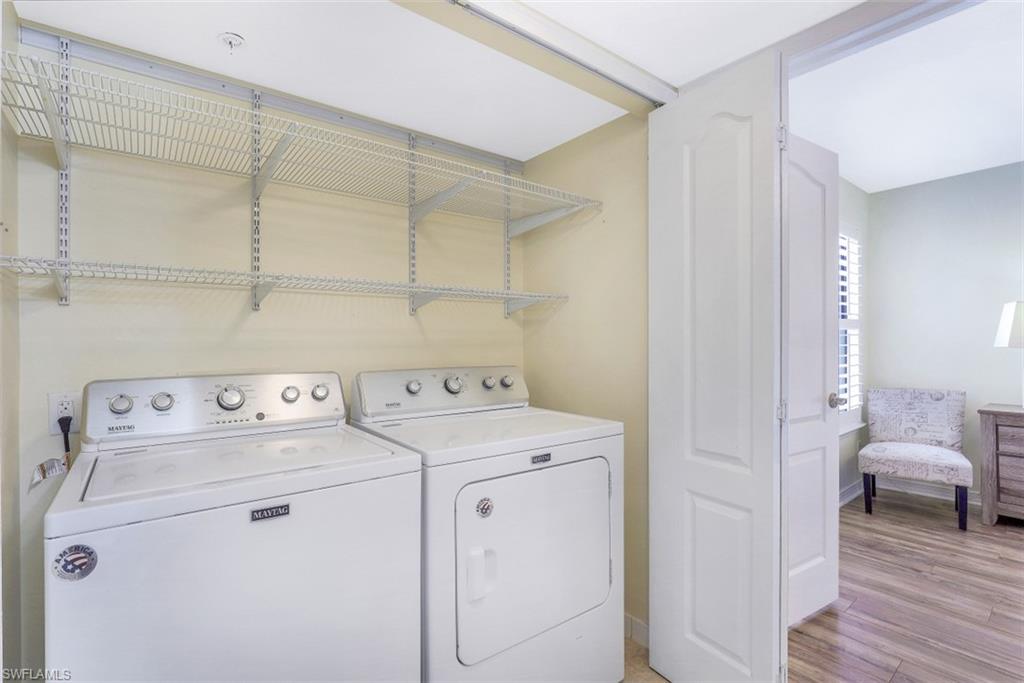 13621 Eagle Ridge Drive, Unit 1522 Fort Myers, FL 33912 - Photo 18 of 22 a view of washer and dryer with bathroom in the background