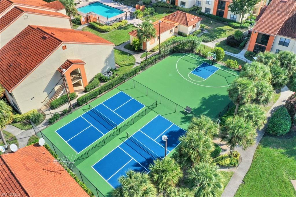 13621 Eagle Ridge Drive, Unit 1522 Fort Myers, FL 33912 - Photo 20 of 22 an aerial view of a tennis ground and a yard