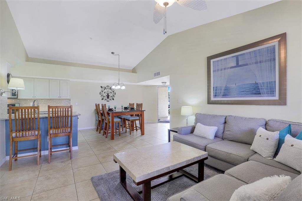 13621 Eagle Ridge Drive, Unit 1522 Fort Myers, FL 33912 - Photo 5 of 22 a living room with furniture and a table