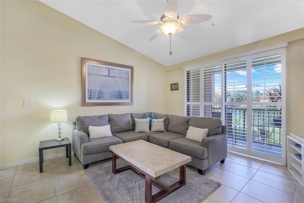 13621 Eagle Ridge Drive, Unit 1522 Fort Myers, FL 33912 - Photo 6 of 22 a living room with furniture and a large window
