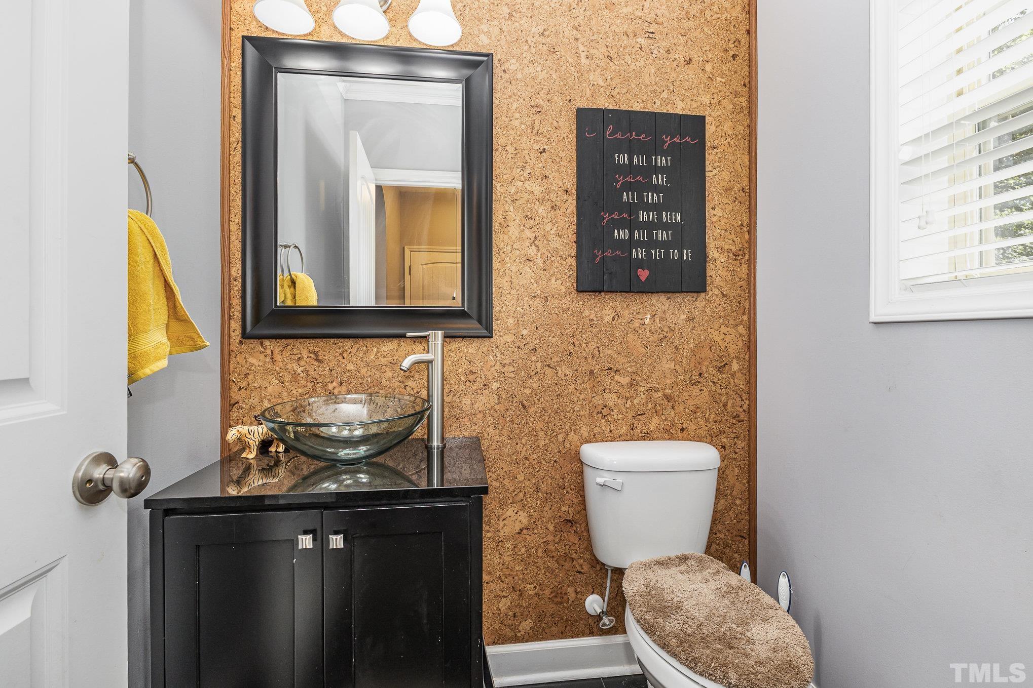 1604 Hauser Lake Road Knightdale, NC 27545 - Photo 16 of 32 a bathroom with a toilet a sink and mirror