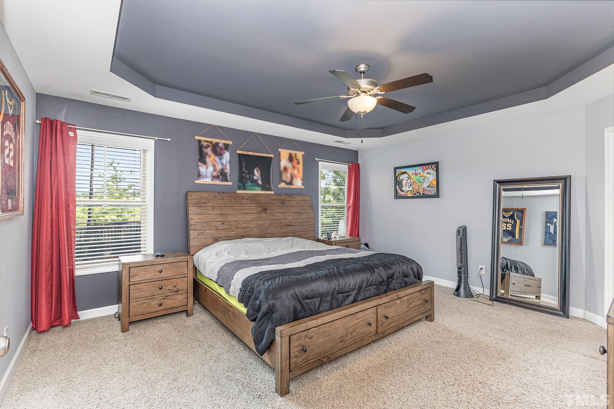 1604 Hauser Lake Road Knightdale, NC 27545 - Photo 18 of 32 a spacious bedroom with a bed and a ceiling fan