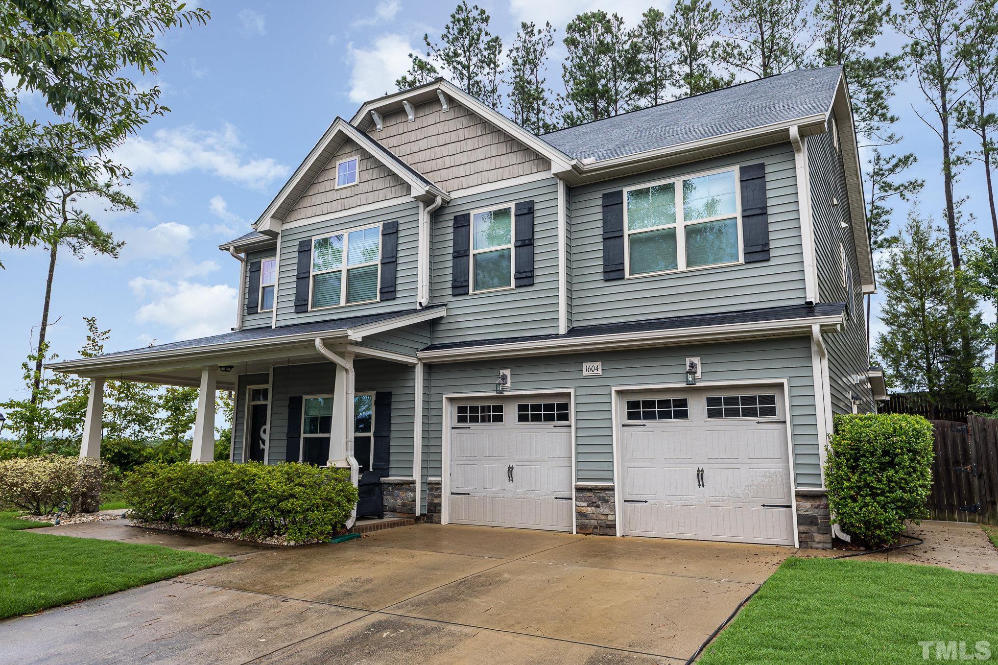 1604 Hauser Lake Road Knightdale, NC 27545 - Photo 2 of 32 a front view of a house with a yard and potted plants
