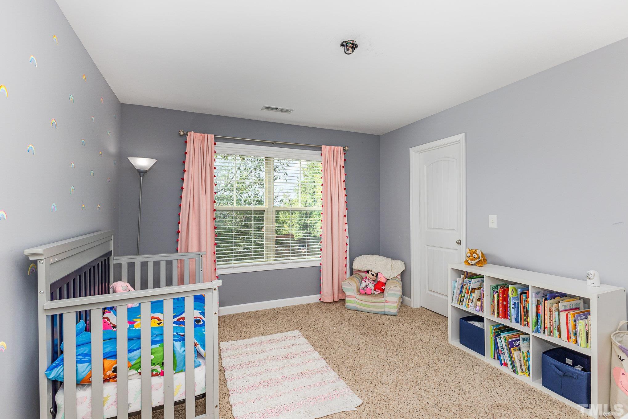 1604 Hauser Lake Road Knightdale, NC 27545 - Photo 23 of 32 a bedroom with furniture a baby crib and a window