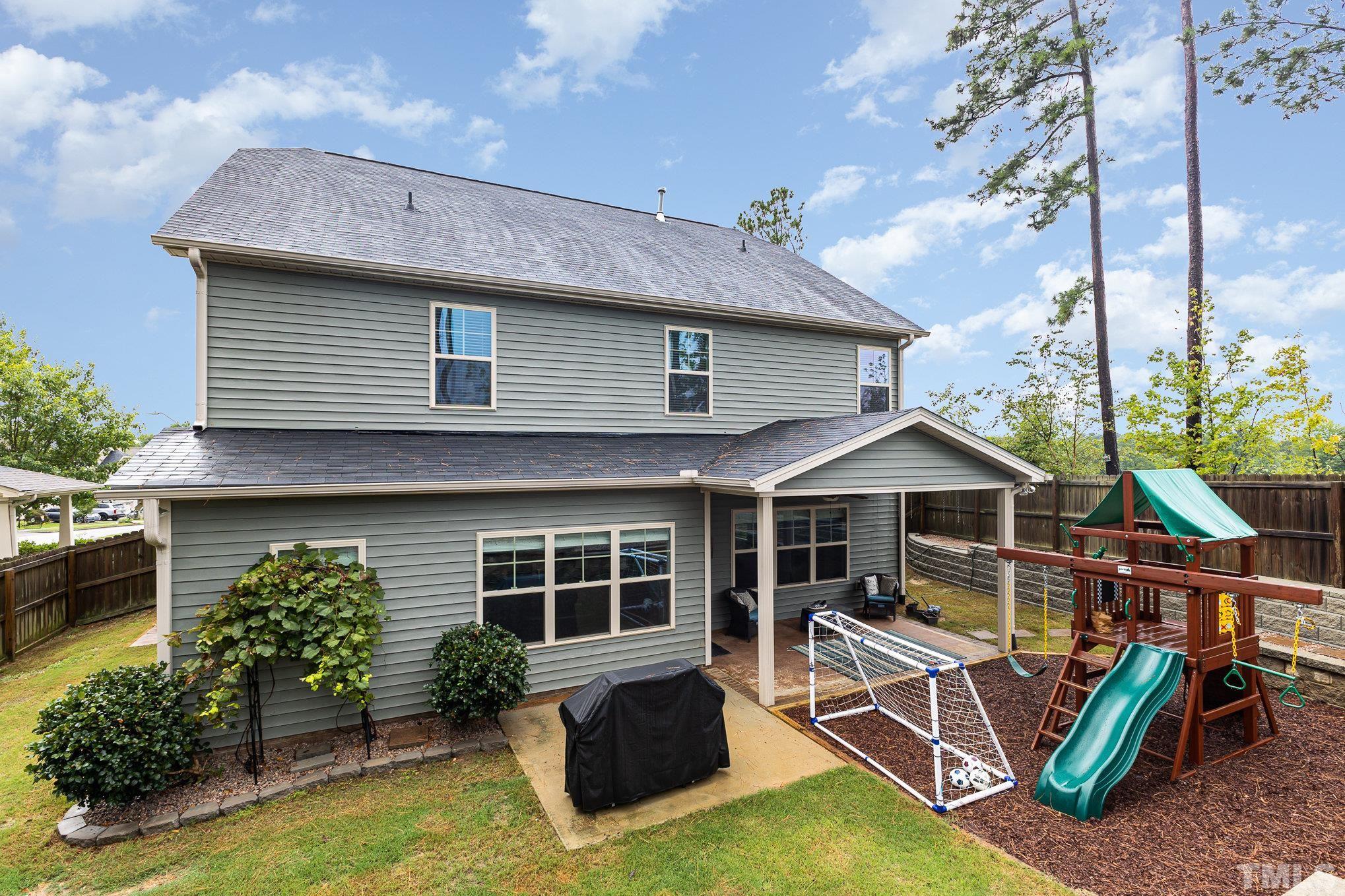 1604 Hauser Lake Road Knightdale, NC 27545 - Photo 29 of 32 a view of a house with backyard porch and sitting area
