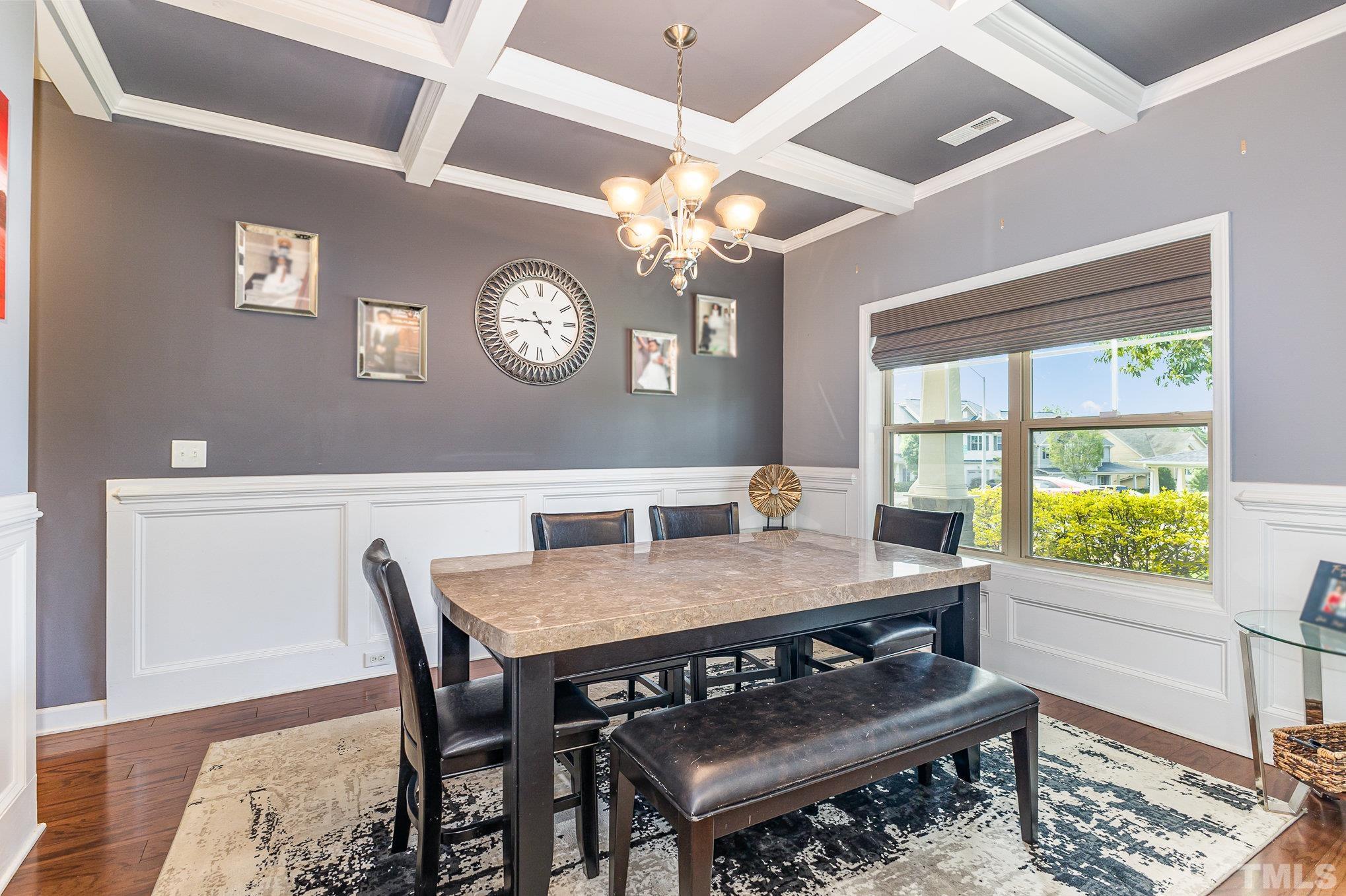 1604 Hauser Lake Road Knightdale, NC 27545 - Photo 8 of 32 a view of a dining room with furniture a chandelier and wooden floor
